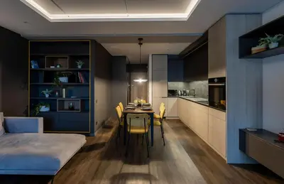 a room with a bed and a table and a kitchen at Vincent City Luxe - Near Clinic, Arena and Stadium in Kaunas