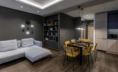 a living room with a couch and a table with chairs at Vincent City Luxe - Near Clinic, Arena and Stadium in Kaunas