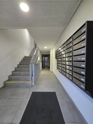a hallway of a building with a staircase and a bunch of empty boxes at Vincent City Luxe - Near Clinic, Arena and Stadium in Kaunas