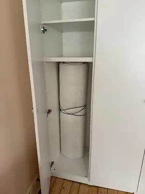 a white closet with a bucket in it at Paupys Cozy Studio in Vilnius