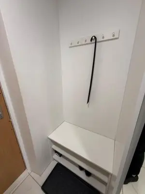 a white closet with a white shelf and a pole at Welcome to Dovas Home in Anykščiai