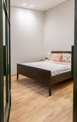 a bedroom with a bed in a white wall at Nordic Apartment in Kaunas Old Town Area and Balcony in Kaunas