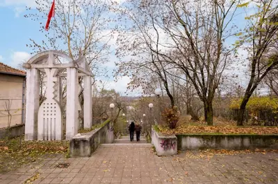 a person walking down a sidewalk in a park at Nordic Apartment in Kaunas Old Town Area and Balcony in Kaunas
