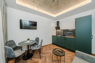 a kitchen and living room with a table and chairs at Chamber House in Kaunas