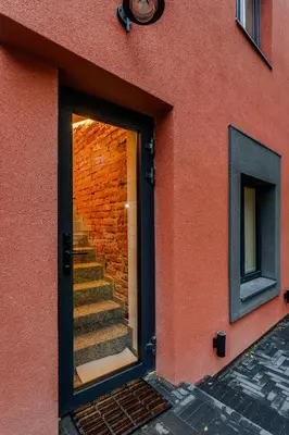 a door to a brick building with a staircase at Chamber House in Kaunas