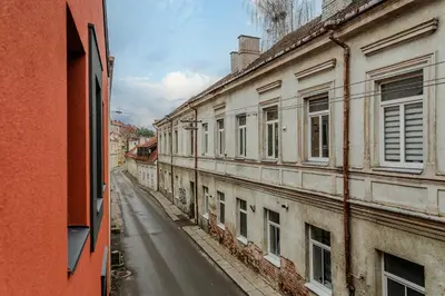 an empty street next to an old building at Chamber House in Kaunas