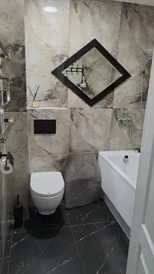 a bathroom with a toilet and a sink and a mirror at Irenos Nuoma in Šiauliai