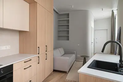 a kitchen with a sink and a couch in a room at Orbis Old Town Suites in Vilnius