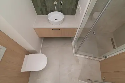 a bathroom with a toilet and a shower at Orbis Old Town Suites in Vilnius