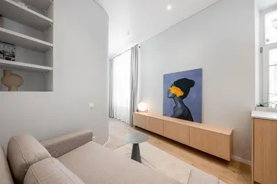 a living room with a couch and a painting on the wall at Orbis Old Town Suites in Vilnius