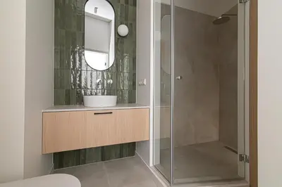 a bathroom with a sink and a shower at Orbis Old Town Suites in Vilnius