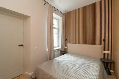 a bedroom with a bed and a window at Orbis Old Town Suites in Vilnius