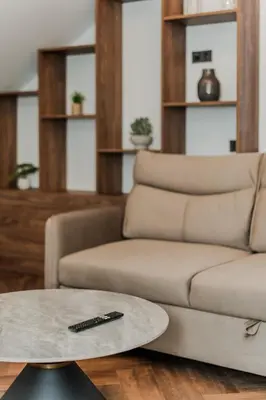 a living room with a couch and a table at Chamber Luxury House in Kaunas