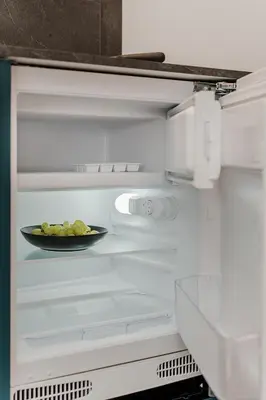 a plate of food in an open refrigerator at Chamber Luxury House in Kaunas