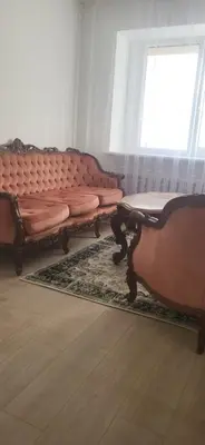 two couches sitting in a room with a window at Vilniaus alėja 4 in Druskininkai