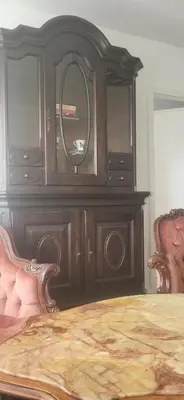 a wooden dresser with a mirror in a bedroom at Vilniaus alėja 4 in Druskininkai
