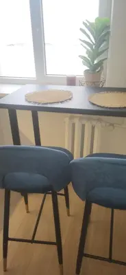 a table with two blue chairs in a room at Vilniaus alėja 4 in Druskininkai