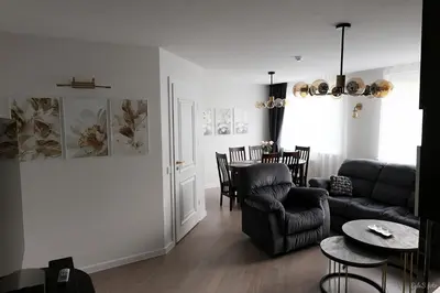 a living room with a couch and a table at Apartamentai Šiaulių miesto centre in Šiauliai