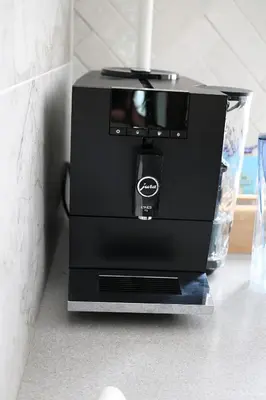 a black coffee maker sitting on a counter at Apartamentai Šiaulių miesto centre in Šiauliai