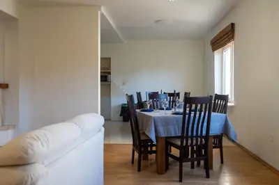a dining room with a table with chairs and a couch at Julias's House in Šiauliai