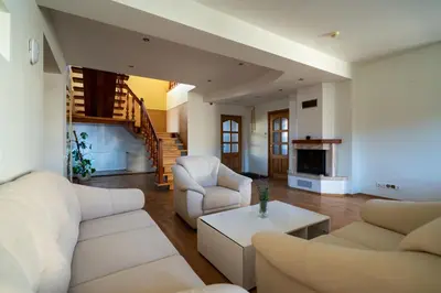 a living room with two white couches and a table at Julias's House in Šiauliai