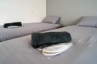 a bed with two beds with towels on it at Julias's House in Šiauliai