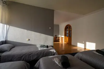 a hotel room with two beds and a hallway at Julias's House in Šiauliai