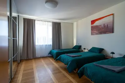 a hotel room with two beds and a window at Julias's House in Šiauliai