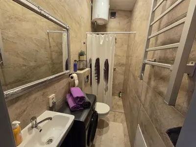 a small bathroom with a sink and a toilet at Jaukus butas Panemunėje su vaizdu į Nemuną in Kaunas