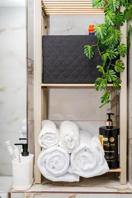 a towel shelf with towels on it at Cozy airport apartment