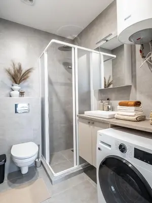 a bathroom with a shower and a washing machine at Cozy Apartment for Rest & Creativity 6 in Vilnius