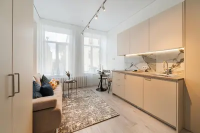 a living room with a couch and a kitchen at Cozy Apartment for Rest & Creativity 6 in Vilnius