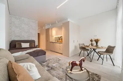 a living room with a couch and a table at Šopeno Butas Cozy Quiet and Well-Located 5 in Vilnius