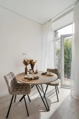 a dining room with a table and two chairs at Šopeno Butas Cozy Quiet and Well-Located 5 in Vilnius