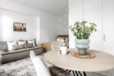 a living room with a table and a couch at Šopeno Butas Cozy Quiet and Well-Located 5 in Vilnius