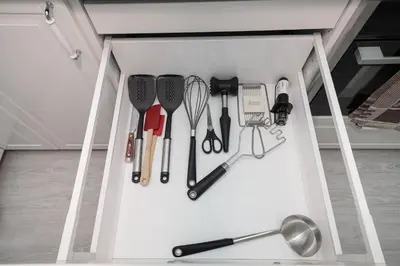 a drawer filled with cooking utensils in a kitchen at Newly Refurbished Luxurious 2 Bedroom Apartment by Reside Baltic in Vilnius