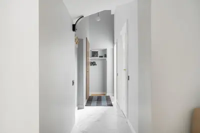 a hallway with white walls and a white hallway at Newly Refurbished Luxurious 2 Bedroom Apartment by Reside Baltic in Vilnius