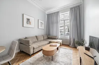 a living room with a couch and a table at Newly Refurbished Luxurious 2 Bedroom Apartment by Reside Baltic in Vilnius