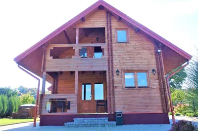 a large wooden house with a large window at Pas Rimute in Zapyškis