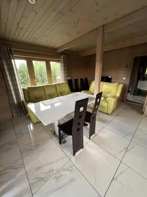 a living room with a table and a couch at Pas Rimute in Zapyškis