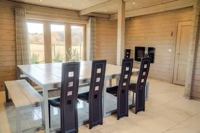 a dining room with a table and four chairs at Pas Rimute in Zapyškis