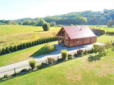 a small house in the middle of a field at Pas Rimute in Zapyškis