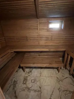 a wooden bench in a room with a window at Pas Rimute in Zapyškis