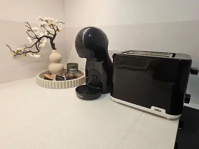 a microwave sitting on a counter next to a vase at Urban oasis apartments in Vilnius