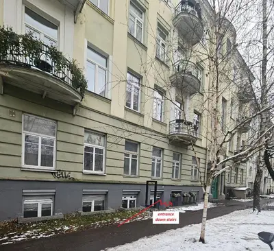 a building with a sign in front of it at Urban oasis apartments in Vilnius