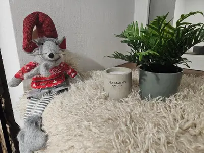 a teddy bear sitting on a pile of fur next to plants at Urban oasis apartments in Vilnius