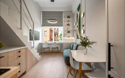 a kitchen and dining room with a table and chairs at 8 Loft in Vilnius