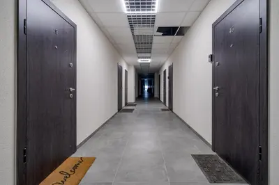 a corridor with wooden doors in a hallway at 8 Loft in Vilnius