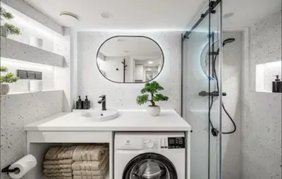 a bathroom with a sink and a washing machine at 8 Loft in Vilnius
