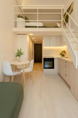 a kitchen and dining room with a table and a bunk bed at 8 Loft in Vilnius
